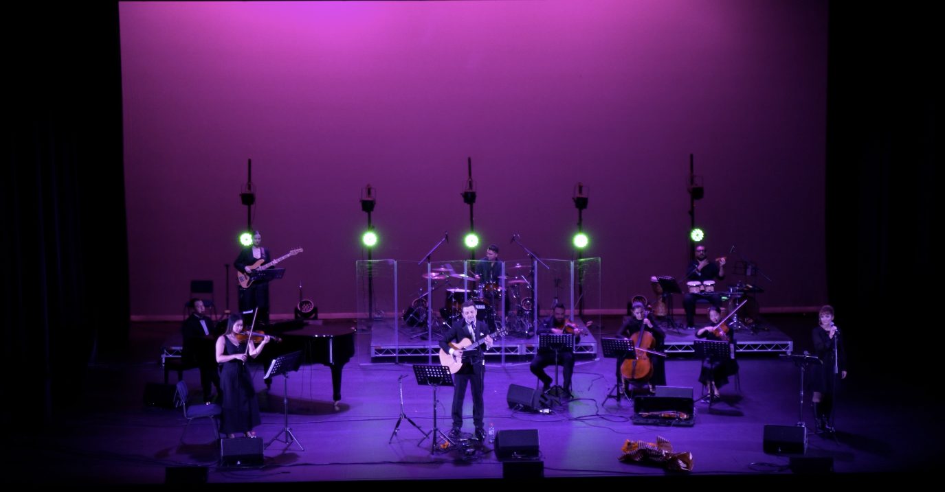 Ali Pahlavan with a string quartet and band on stage at the Seymour Centre